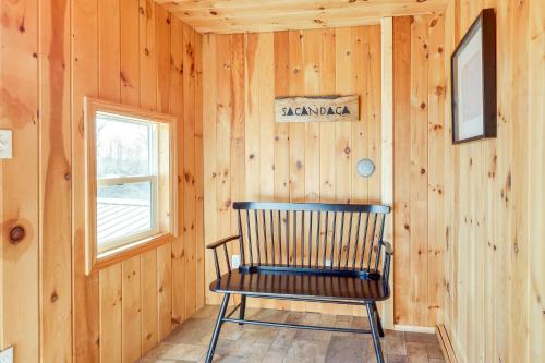 a rocking chair in a room with wooden walls at Walk to Private Beach and Boat Launch Mayfield Home in Broadalbin
