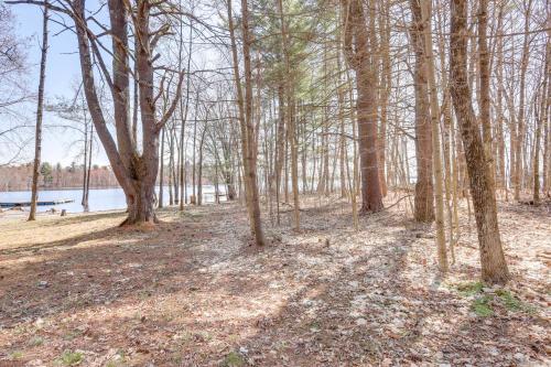 a wooded area with trees and a body of water at Walk to Private Beach and Boat Launch Mayfield Home in Broadalbin