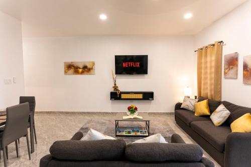 a living room with a couch and a table at Spacious 1 Bedroom Unit with a Fire Pit in the Private Backyard in Anguilla