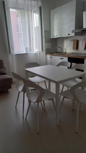 a white table and chairs in a kitchen at MARIANTONIA Apartment And Rooms in Reggio Calabria