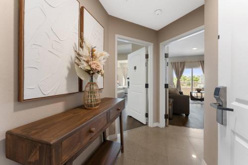 a living room with a vase of flowers on a wooden table at 2 Units Together Kitchen Great Location in Orlando