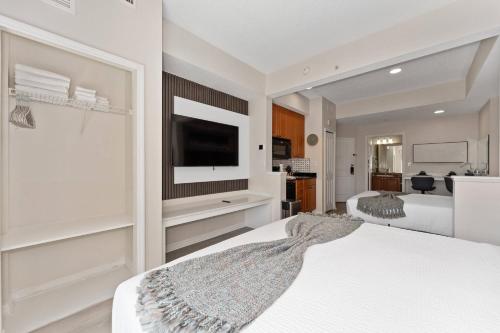 a bedroom with two beds and a flat screen tv at Combined units 2 Kitchens Sleeps 6 in Orlando