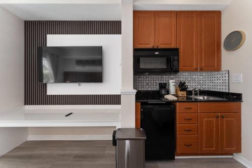 a kitchen with a black refrigerator and a microwave at Combined units 2 Kitchens Sleeps 6 in Orlando