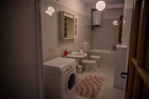 a bathroom with a sink and a washing machine at L'ulivo in Levanto