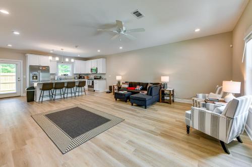 a living room with a couch and a table at 4 Mi to Auburn University Townhome with Fenced Yard in Opelika