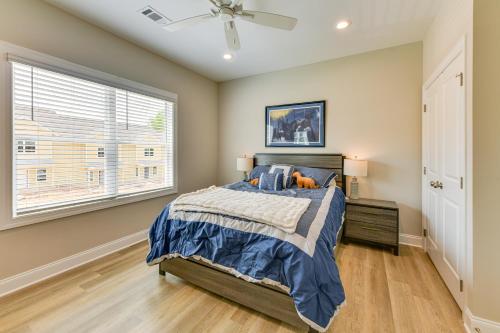 a bedroom with a bed and a window at 4 Mi to Auburn University Townhome with Fenced Yard in Opelika