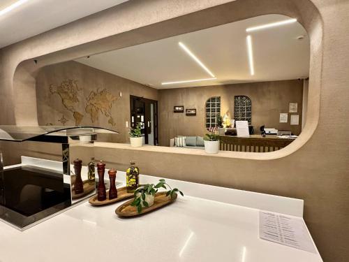 a bathroom with a large mirror over a sink at Castro Hotel in Amoudara Herakliou