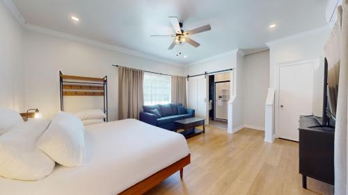 a bedroom with a bed and a couch and a television at The Surf Club in Ocean City