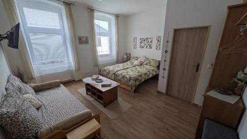 a living room with a couch and a table at Frühstückspension Alte Volksschule Heinrichs bei Weitra in Heinreichs bei Weitra