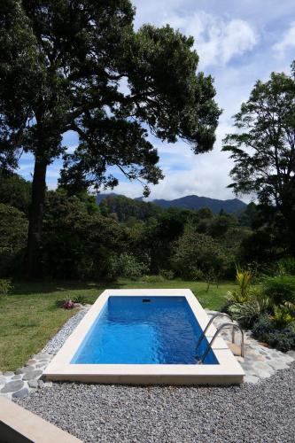 a swimming pool in the middle of a yard at Casitas Vista Verde in Bajo Boquete