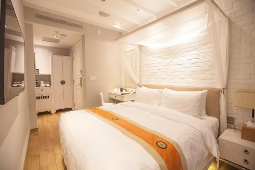Säng eller sängar i ett rum på Hotel NuVe Heritage