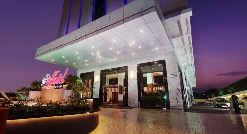 a building with a person standing outside of it at night at Effotel By Sayaji Indore in Indore