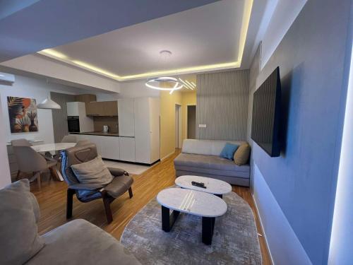 a living room with a couch and a table at Gigi Apartment by eluxory in Skopje