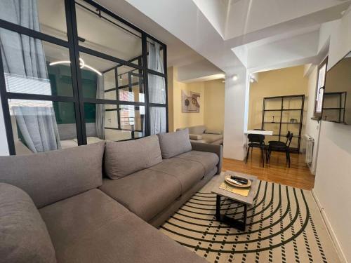 a living room with a couch and a table at Gigi Apartment by eluxory in Skopje