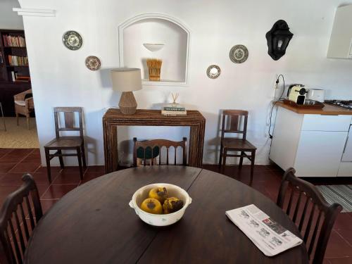 a dining room table with a bowl of fruit on it at Herdade do Vidigal in Montemor-o-Novo