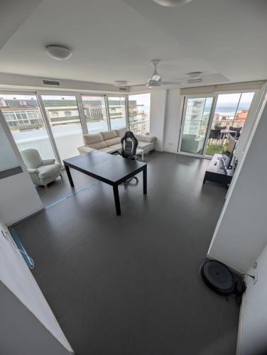 a living room with a couch and a coffee table at Remolins Bloque 2 9B Benicàssim zona Torreón in Benicàssim