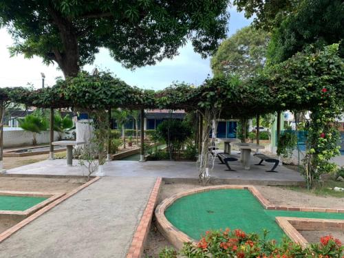 a garden with a green lawn and a pavilion at Cabaña en coveñas en acogedor conjunto residencial in Coveñas