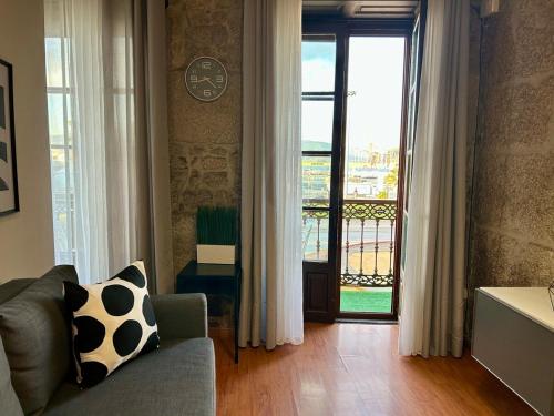 a living room with a couch and a sliding glass door at Ubicacion inigualable in Vigo