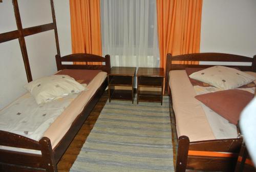 two bunk beds in a room with a table at Cabana Tei in Azuga