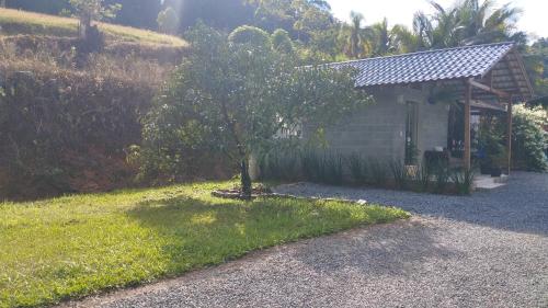 a small house with a tree in the yard at Casa Primavera in Pomerode
