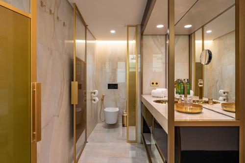 a bathroom with two sinks and a toilet at Madalena by The Beautique Hotels in Lisbon