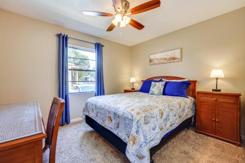a bedroom with a bed and a ceiling fan at Walk to St Augustine Beach! Condo with Pool Access in Saint Augustine Beach