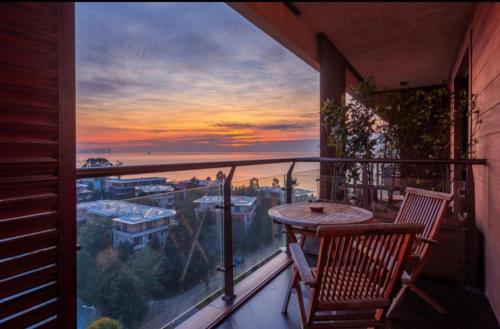 a balcony with a table and a view of the ocean at Dream Land Oasis 14-704 apartment in Chakvi