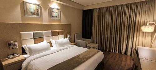 a hotel room with a large bed with white pillows at Dream Land Oasis 14-704 apartment in Chakvi