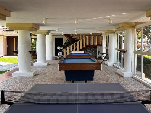 a row of tables on a building with a staircase at Hotel Quinta Rivera in Actopan