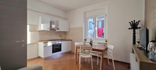 a kitchen with a table and chairs and a dining room at Billotti in Biella