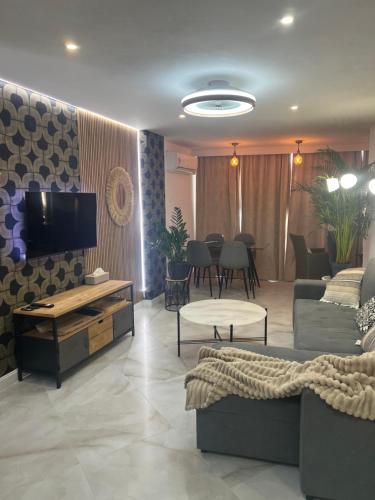 a living room with a couch and a tv at BENILOVE en PLAYA in Benidorm