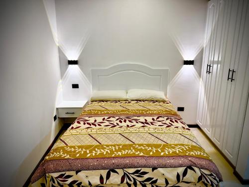 a bedroom with a bed with two lights on it at Casa Elalu in Quito