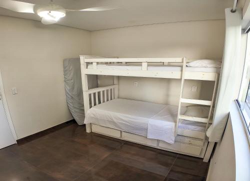 a bedroom with two bunk beds in a room at Moradas do Campeche CSABC in Florianópolis