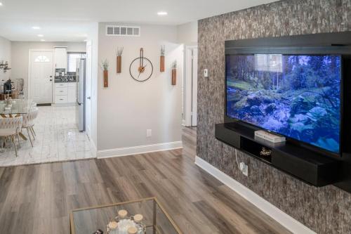a living room with a large flat screen tv at Elegant Home Mins from DTW in Dearborn Heights