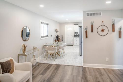 a dining room and living room with a table and chairs at Elegant Home Mins from DTW in Dearborn Heights
