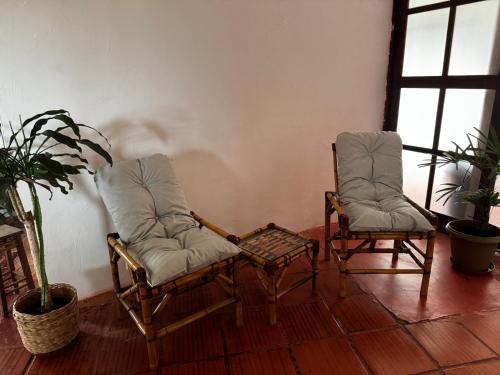 two chairs and a table in a living room at Pousada Casarão de Itaúnas in Itaúnas