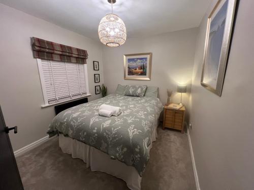 a small bedroom with a bed and a window at Olive Tree Cottage in Golcar
