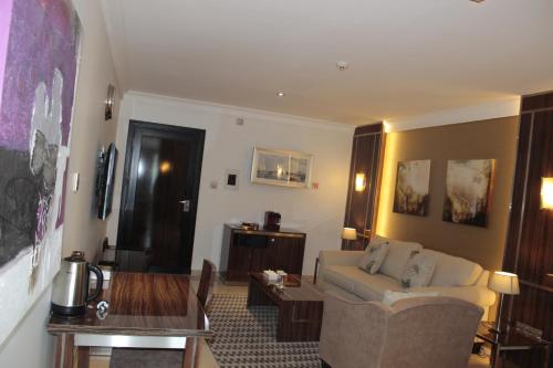 a living room with a couch and a table at Tio Sea Resort in Al Khor