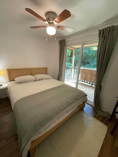 a bedroom with a bed and a ceiling fan at The Black Bear Cabin in Klamath