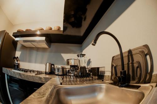 a kitchen with a sink and a counter top at Departamento Rosa & Chocolate 8A in Matehuala