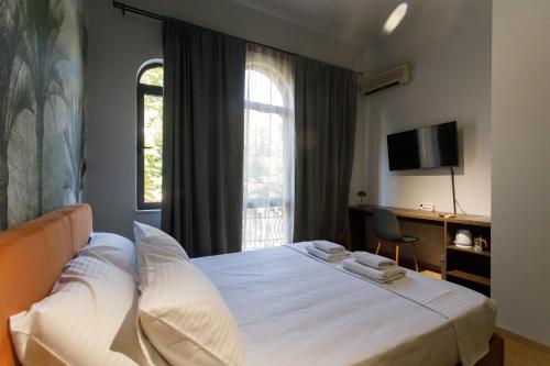 a hotel room with a bed and a window at SA Studio 24 in Tirana