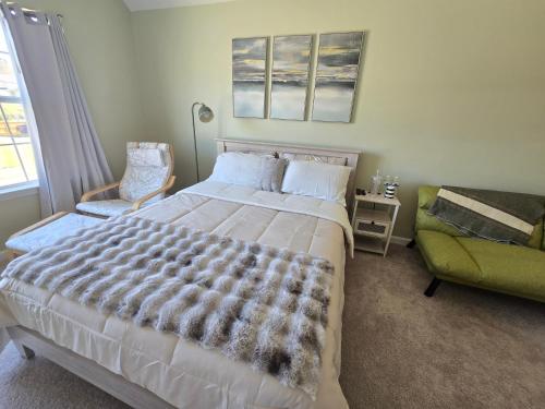 a bedroom with a large bed and a green couch at Luxury affordable Room in Quite area in Atlanta in Atlanta