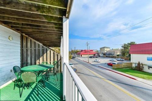 a balcony with a green table and a street at 300 ROBIN DR Walking Distance to Beach in Ocean City