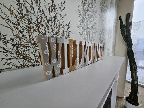 a white table with a bunch of art on it at Ferienappartement-Abendsonne-3 in Mirow