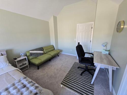 a bedroom with a bed and a couch and a desk at Luxury affordable Room in Quite area in Atlanta in Atlanta