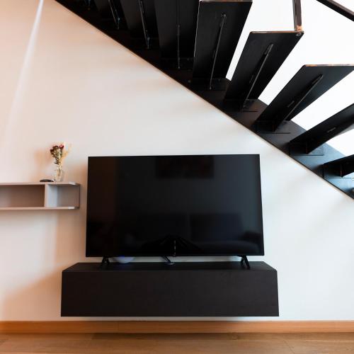 a flat screen tv sitting on a stand in a living room at Antica Corte Lugo in Lugo