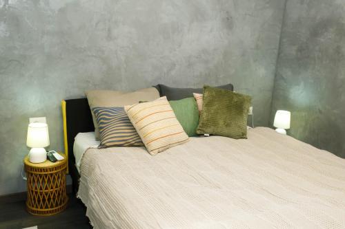 a bedroom with a bed with pillows on it at SA Studio 24 in Tirana