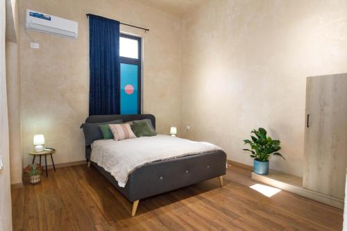 a bedroom with a bed and a window at SA Studio 24 in Tirana