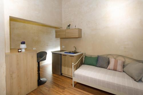 a room with a couch and a sink and a kitchen at SA Studio 24 in Tirana
