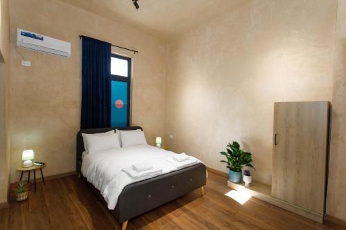 a bedroom with a bed and a window at SA Studio 24 in Tirana